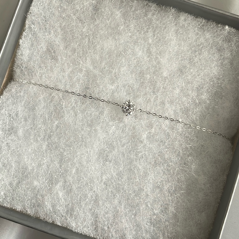 NWT silver bracelet with a small zirconia stone in center.